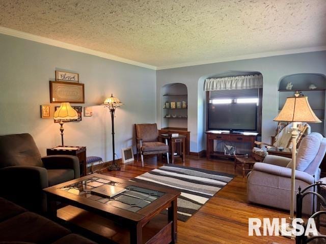 living area featuring a textured ceiling, wood finished floors, and ornamental molding