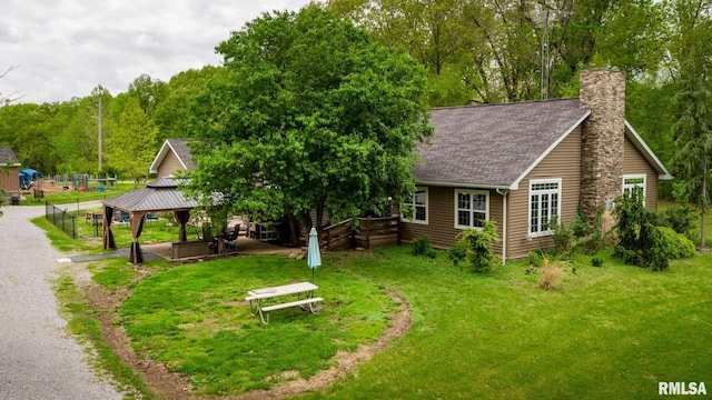 17503 N Woodlawn Ln, Woodlawn, IL 62898 - back of property with a gazebo, a chimney, a yard, and roof with shingles