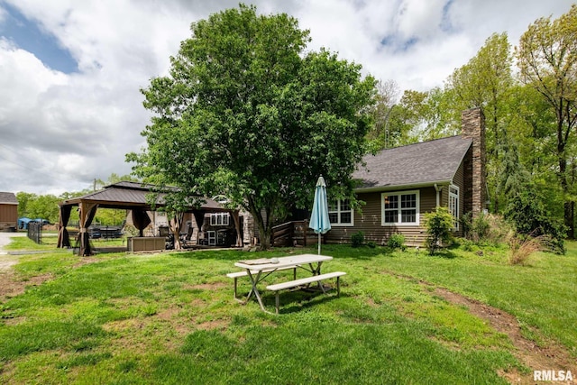 17503 N Woodlawn Ln, Woodlawn, IL 62898 - back of property featuring a gazebo, a yard, a chimney, and a shingled roof