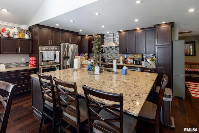 17503 N Woodlawn Ln, Woodlawn, IL 62898 - kitchen with stainless steel appliances, wall chimney exhaust hood, dark wood-type flooring, dark brown cabinetry, and decorative backsplash