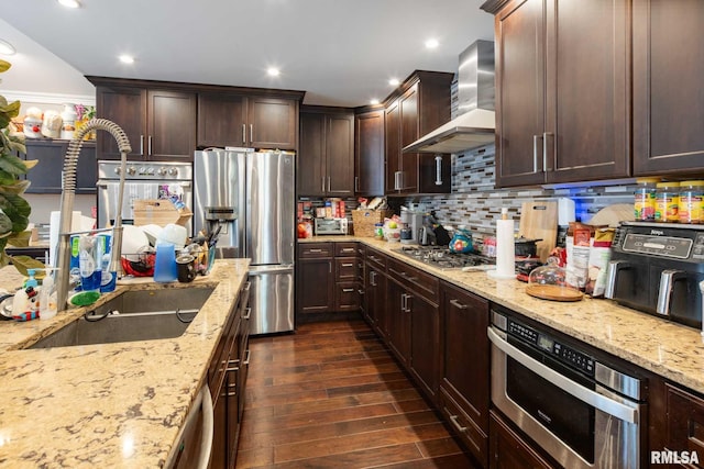 17503 N Woodlawn Ln, Woodlawn, IL 62898 - kitchen with wall chimney range hood, stainless steel appliances, light stone countertops, backsplash, and recessed lighting