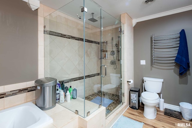 17503 N Woodlawn Ln, Woodlawn, IL 62898 - bathroom with a stall shower, ornamental molding, toilet, wood finished floors, and a garden tub