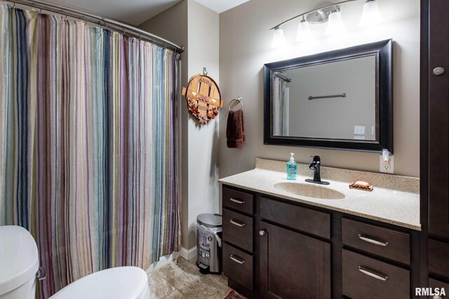 17503 N Woodlawn Ln, Woodlawn, IL 62898 - bathroom with toilet, vanity, and curtained shower