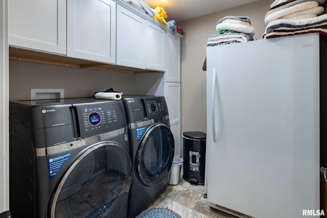 17503 N Woodlawn Ln, Woodlawn, IL 62898 - laundry area with washing machine and clothes dryer, cabinet space, and light stone finish floors