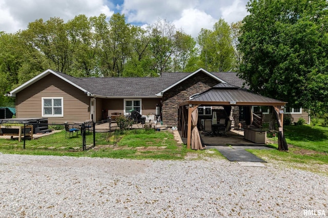 17503 N Woodlawn Ln, Woodlawn, IL 62898 - view of front facade with a gazebo, stone siding, fence, and view of scattered trees