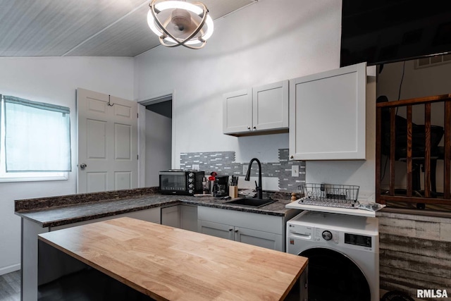 17503 N Woodlawn Ln, Woodlawn, IL 62898 - kitchen with a sink, washer / dryer, butcher block counters, lofted ceiling, and black microwave