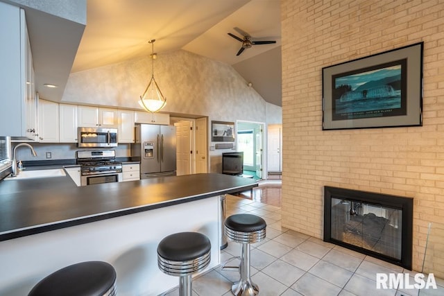 12 Old Marion Rd, West Frankfort, IL 62896 - kitchen with appliances with stainless steel finishes, a sink, dark countertops, high vaulted ceiling, and light tile patterned flooring