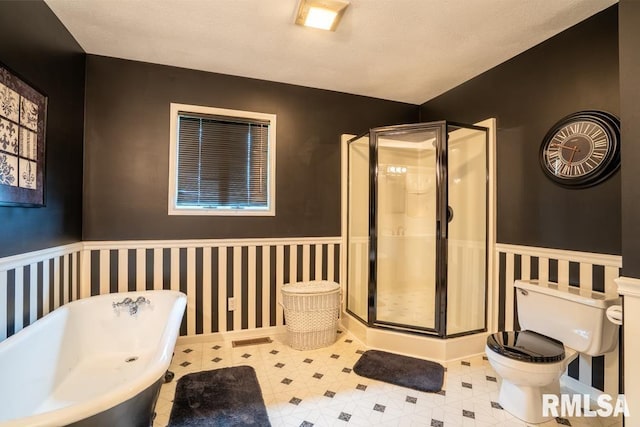 12 Old Marion Rd, West Frankfort, IL 62896 - bathroom featuring a wainscoted wall, toilet, a stall shower, and a freestanding bath