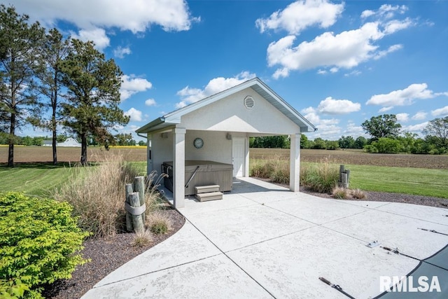 12 Old Marion Rd, West Frankfort, IL 62896 - view of community featuring a hot tub, a patio area, concrete driveway, and a yard
