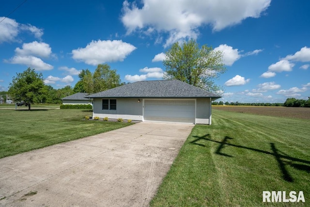12 Old Marion Rd, West Frankfort, IL 62896 - view of front facade featuring a front lawn, concrete driveway, stucco siding, and an attached garage