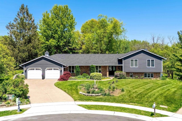 4105 Apple Valley Dr, Bettendorf, IA 52722 - tri-level home featuring concrete driveway, an attached garage, a front yard, and brick siding