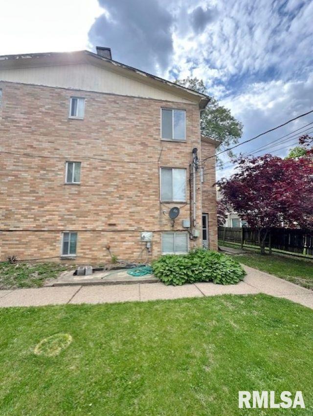 view of property exterior with brick siding