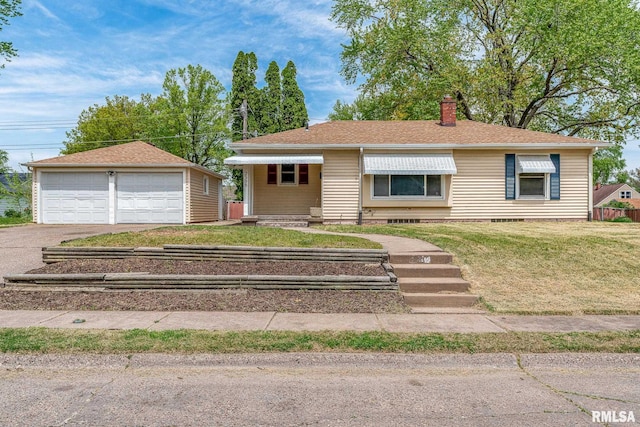 view of front of house with a detached garage, a chimney, an outbuilding, and a front yard
