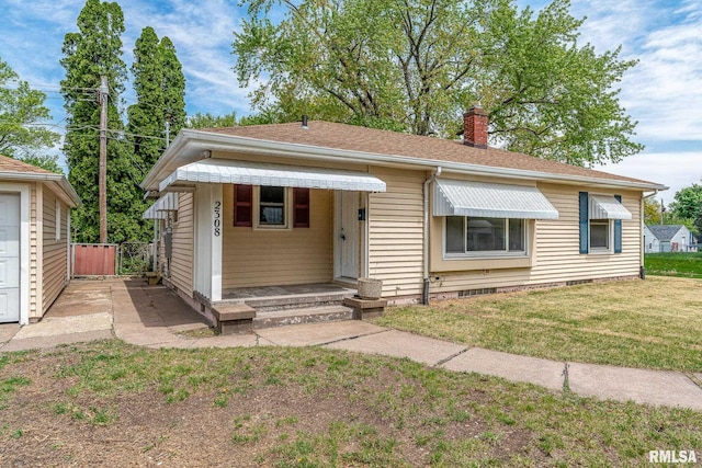 bungalow with a chimney, a front yard, and crawl space