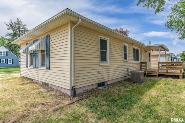 view of side of home featuring a deck, a yard, central AC unit, and crawl space