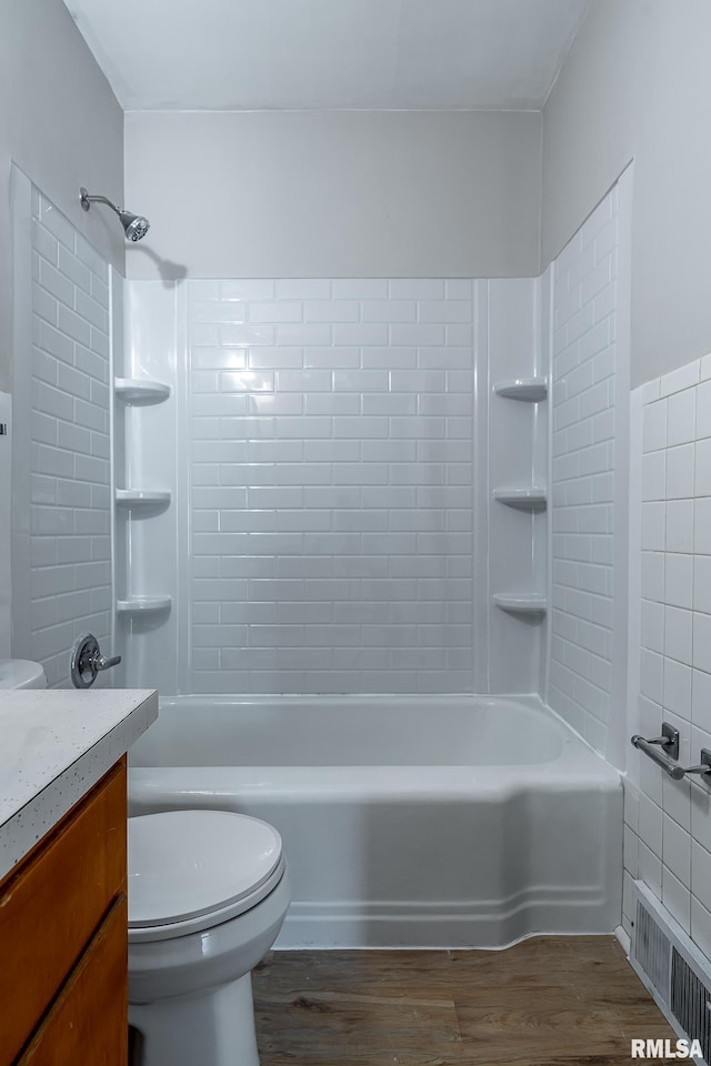 full bathroom featuring wood finished floors, toilet, tub / shower combination, and vanity