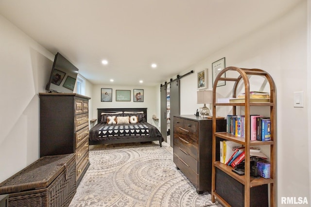 bedroom featuring a barn door and recessed lighting