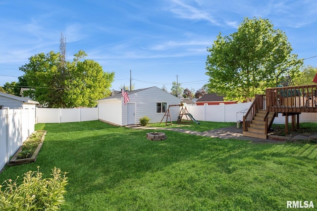 view of yard with a playground and a wooden deck