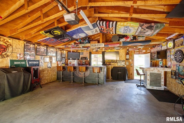 garage featuring a garage door opener and a workshop area