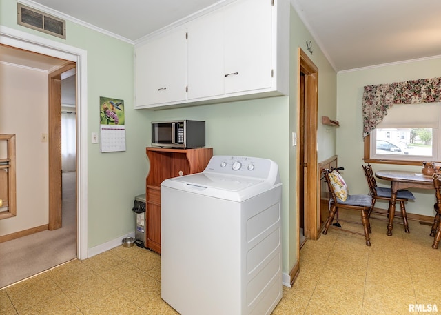 laundry room featuring washer / clothes dryer, light flooring, cabinet space, baseboards, and ornamental molding
