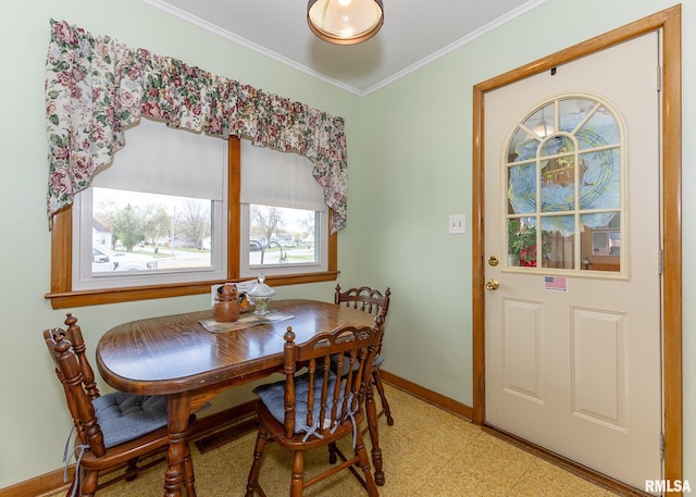 dining room with light flooring, baseboards, and crown molding