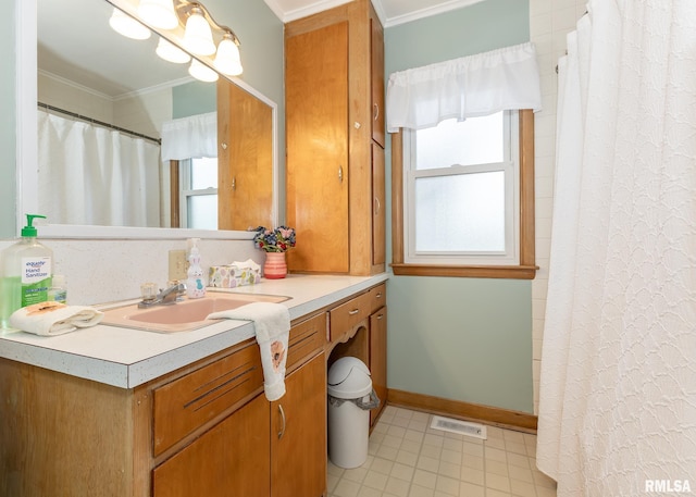 bathroom featuring ornamental molding, vanity, a shower with curtain, and baseboards