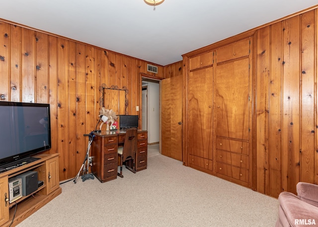 office featuring carpet flooring and wood walls
