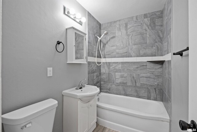 2116 W 68th St, Davenport, IA 52806 - full bath featuring shower / washtub combination, toilet, wood finished floors, and vanity