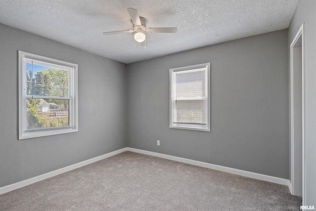 2116 W 68th St, Davenport, IA 52806 - unfurnished room featuring carpet flooring, a ceiling fan, baseboards, and a textured ceiling