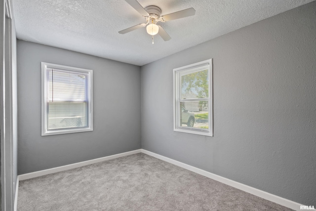 2116 W 68th St, Davenport, IA 52806 - carpeted empty room with a textured ceiling, ceiling fan, and baseboards