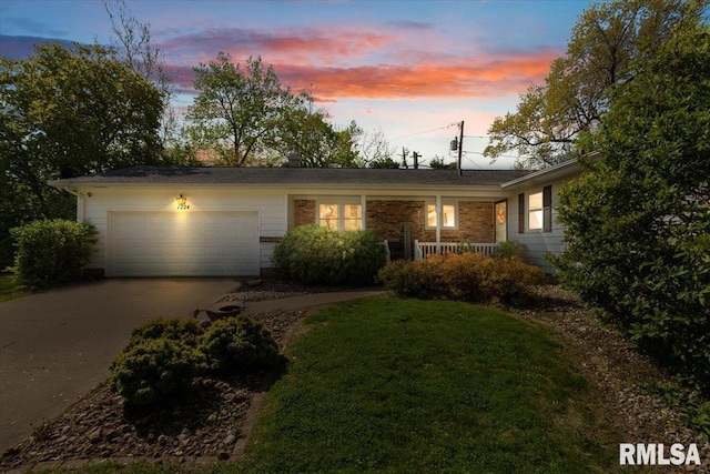 single story home with concrete driveway, a garage, a front lawn, and a porch