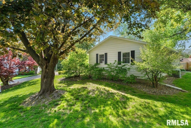 view of side of property with a lawn