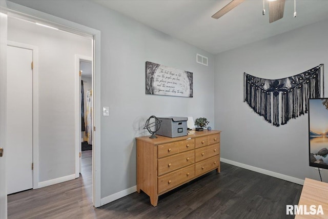 sitting room featuring dark wood-style flooring, a ceiling fan, and baseboards