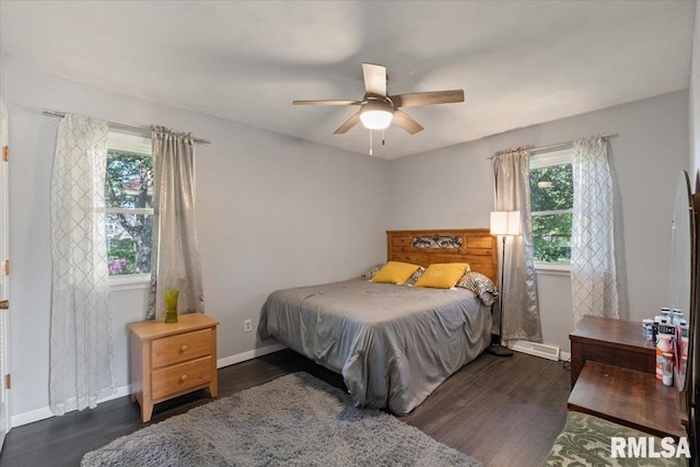 bedroom featuring wood finished floors, baseboards, and a ceiling fan