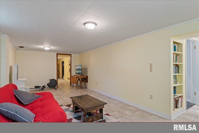 living room featuring ornamental molding, baseboards, and built in features