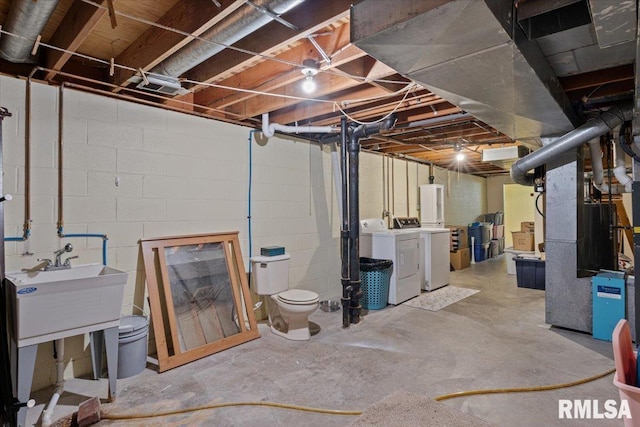 unfinished basement with washer and dryer and heating unit