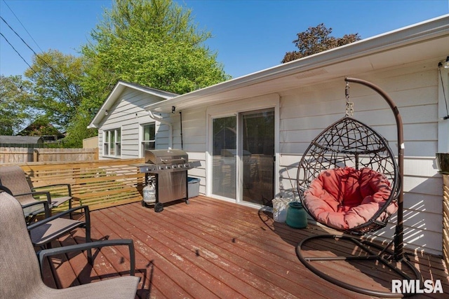 deck featuring grilling area and fence