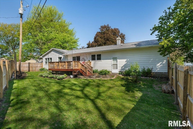 rear view of property with a wooden deck and a chimney