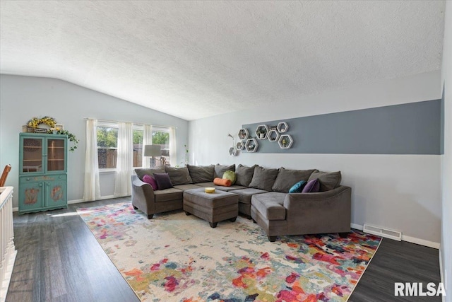 living area featuring wood finished floors, lofted ceiling, a textured ceiling, and baseboards