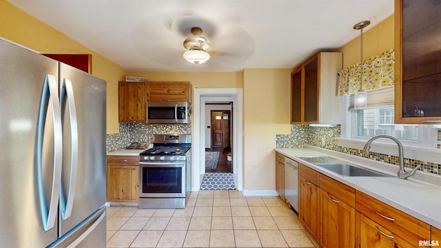 2117 Harrison St, Davenport, IA 52803 - kitchen featuring stainless steel appliances, ceiling fan, backsplash, and light countertops