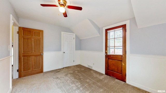 2117 Harrison St, Davenport, IA 52803 - bonus room with wainscoting, lofted ceiling, ceiling fan, and carpet floors