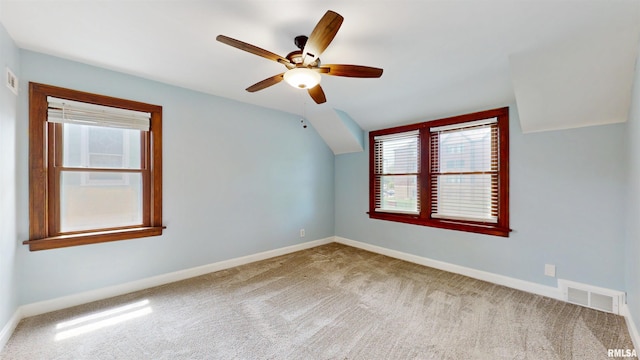 2117 Harrison St, Davenport, IA 52803 - empty room with lofted ceiling, baseboards, carpet floors, and a ceiling fan