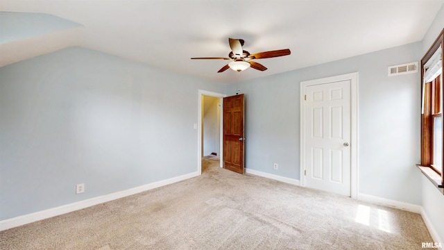 2117 Harrison St, Davenport, IA 52803 - unfurnished bedroom with light carpet, baseboards, and a ceiling fan