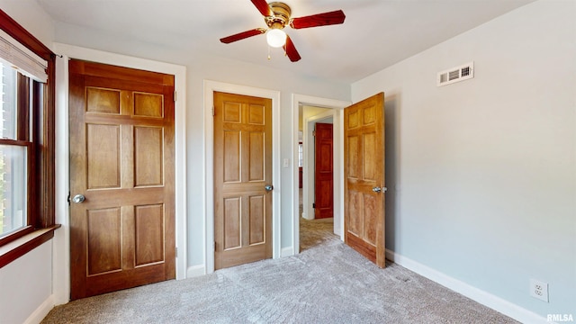 2117 Harrison St, Davenport, IA 52803 - unfurnished bedroom with carpet, baseboards, and ceiling fan