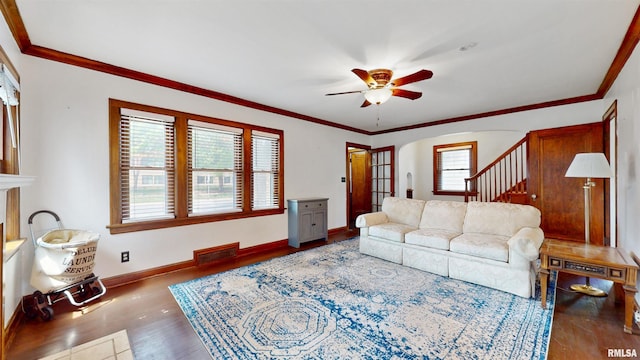 2117 Harrison St, Davenport, IA 52803 - living area featuring a ceiling fan, wood finished floors, stairs, arched walkways, and baseboards