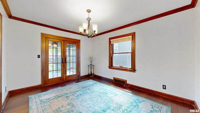 2117 Harrison St, Davenport, IA 52803 - spare room with healthy amount of natural light, a chandelier, wood finished floors, french doors, and ornamental molding