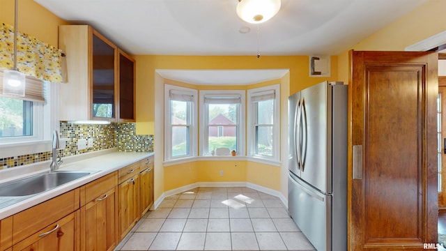 2117 Harrison St, Davenport, IA 52803 - kitchen with freestanding refrigerator, a sink, plenty of natural light, and light tile patterned floors
