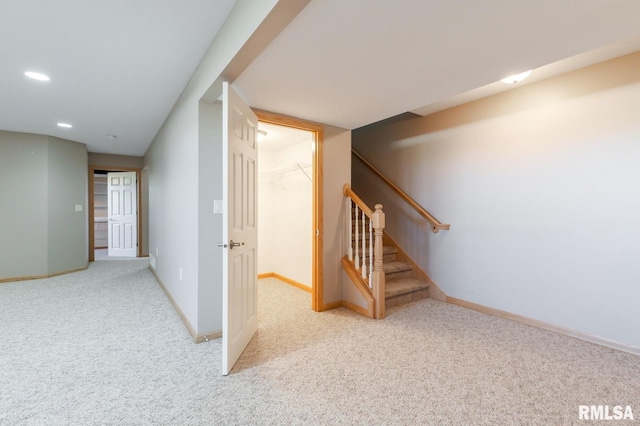 finished below grade area with carpet floors, baseboards, stairs, and recessed lighting