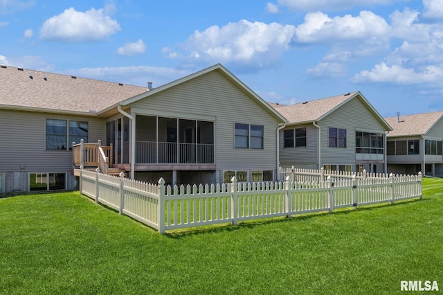 rear view of property with a sunroom and a shingled roof