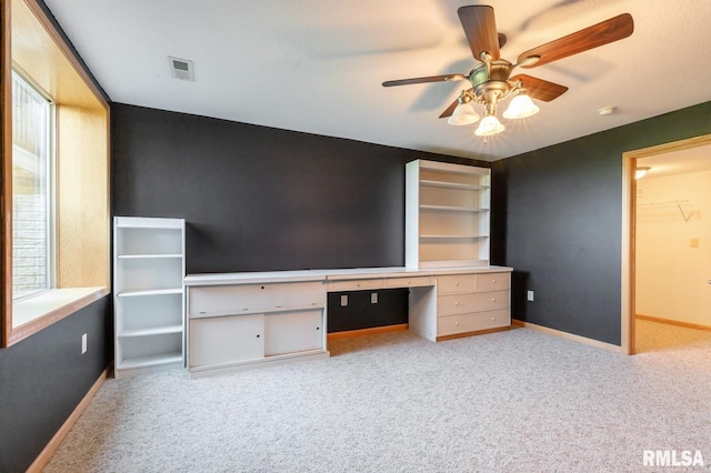 unfurnished bedroom with carpet flooring, baseboards, and ceiling fan